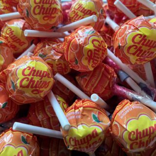 Bulk bin of Orange Chupa Chups lollipops